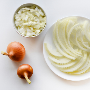 White onions prepared whole, sliced, and chopped showing the different ways you can use them.