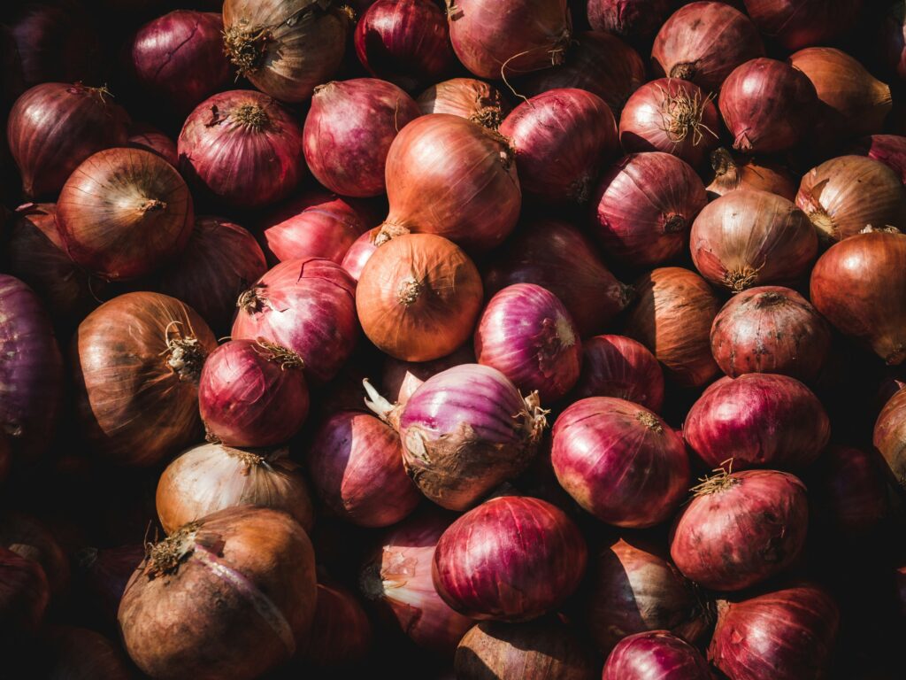 A pile of red and yellow onions.